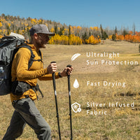 Golden - hiker wearing sun hoodie while hiking across autumn meadow