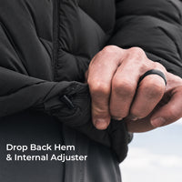 Close-up of a person's hands adjusting the hem of a black puffer jacket, with text reading 'Drop Back Hem & Internal Adjuster' on the lower left.