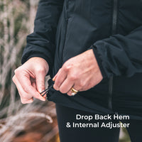 Close-up of a person wearing a black zip-front jacket and pulling a black cord at the back hem, with the text 'Drop Back Hem & Internal Adjuster' overlaid on the lower right.
