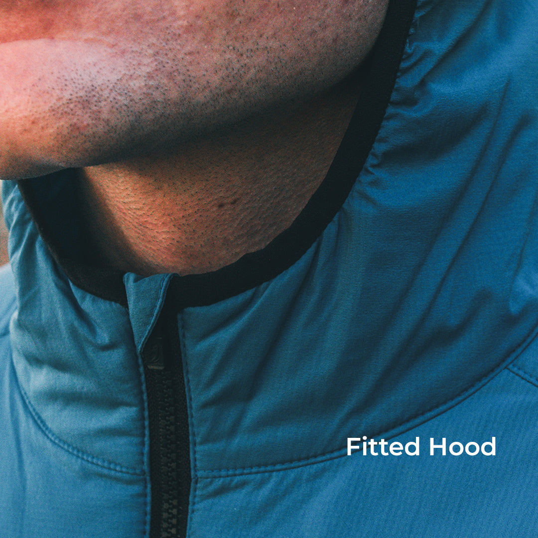 Close-up of a person wearing a fitted blue hooded jacket, showing the zipper, neck, and chin area with the text 'Fitted Hood' overlaid in the lower right.