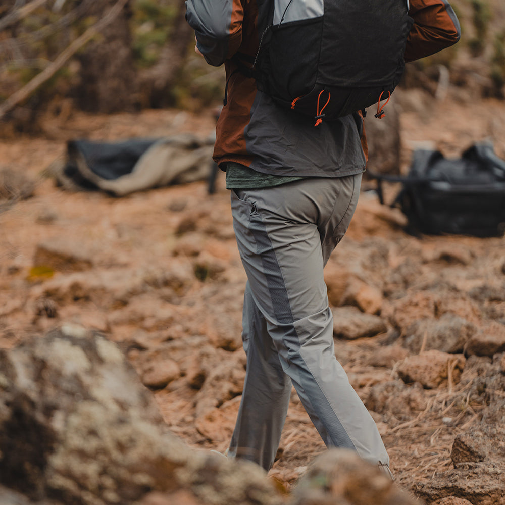 rear view of backpacker hiking with well ventilated hiking pants