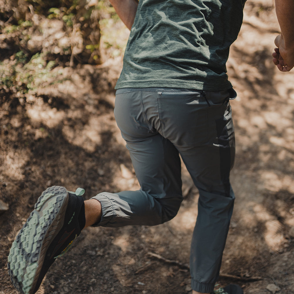 rear view of trail runner wearing comfortable & mobile joggers while running