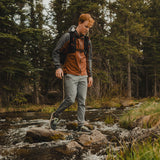 wide front view of hiker wearing ultralight joggers while crossing a stream