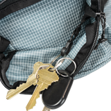 Close-up of the Shadowlight Ultralight Backpack's hip belt pocket with attached key clip