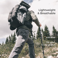 rear view of hiker wearing gray vented pants hiking up mountain slope