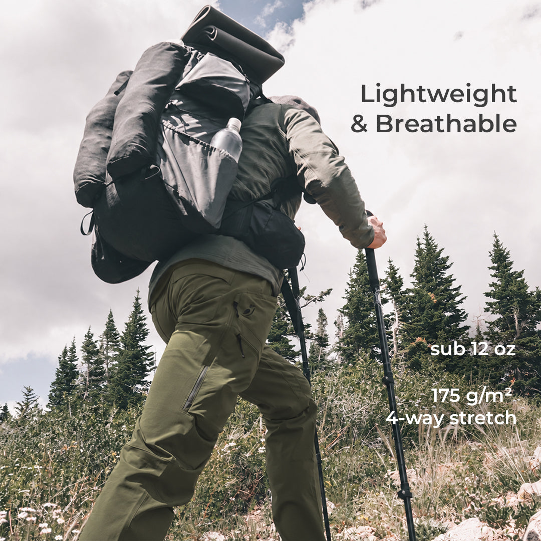 backpacker wearing green hiking pants with a few pockets visible while hiking up mountainside