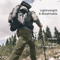 backpacker wearing green hiking pants with a few pockets visible while hiking up mountainside