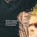 Close-up of a person wearing a dark insulated jacket with a textured, dotted brown fabric panel on the side, set against a blurred outdoor background. White text on the image reads 'Body-Mapped Breathability & Insulation'.