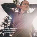 A woman outdoors wearing a fitted long-sleeve quarter-zip athletic top, with bright sunlight and lens flare over the front. White text at the lower left reads 'Body-Mapped Breathability & Insulation.