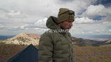 ultralight down jacket shown on high mountain ridge throughout video