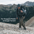 man hikes up steep mountain incline while wearing lightweight pants