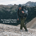 man wearing technical pants for mountains hiking up steep mountain peak