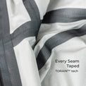 Close-up of a white ribbed fabric with dark gray diagonal stripes and text reading 'Every Seam Taped TORAIN™ tech'.