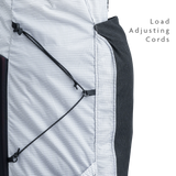 Close-up of backpack side panel showing adjustable load-compression cords.