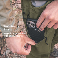 close view of man putting phone in angled cargo pocket of lightweight hiking pants