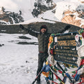 man wearing warm puffy jacket at high mountain pass