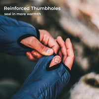 Close-up of a person wearing a blue puffer glove with thumbhole opening and black reinforced trim, adjusting the thumb area. White text at the top reads 'Reinforced Thumbholes' and 'seal in more warmth.