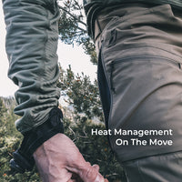 man unzips mesh-backed side vent in high mountain environment