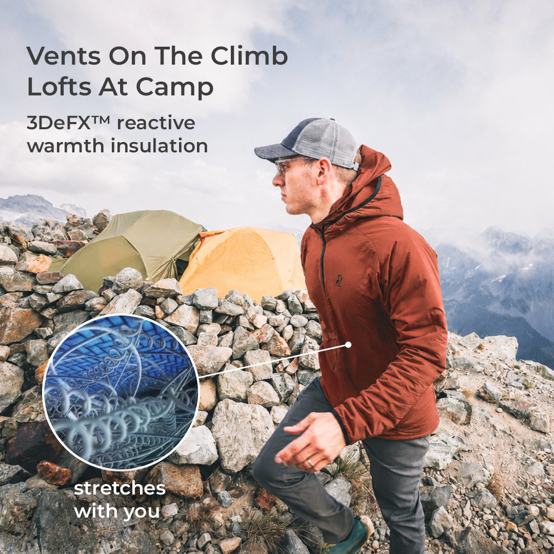 A man wearing a 3DeFX jacket and gray cap hikes along a rocky mountain trail, with tents in the background and text overlays highlighting breathability and stretch technology.