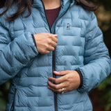 Close-up of women’s insulated down jacket zipper and front baffle construction.