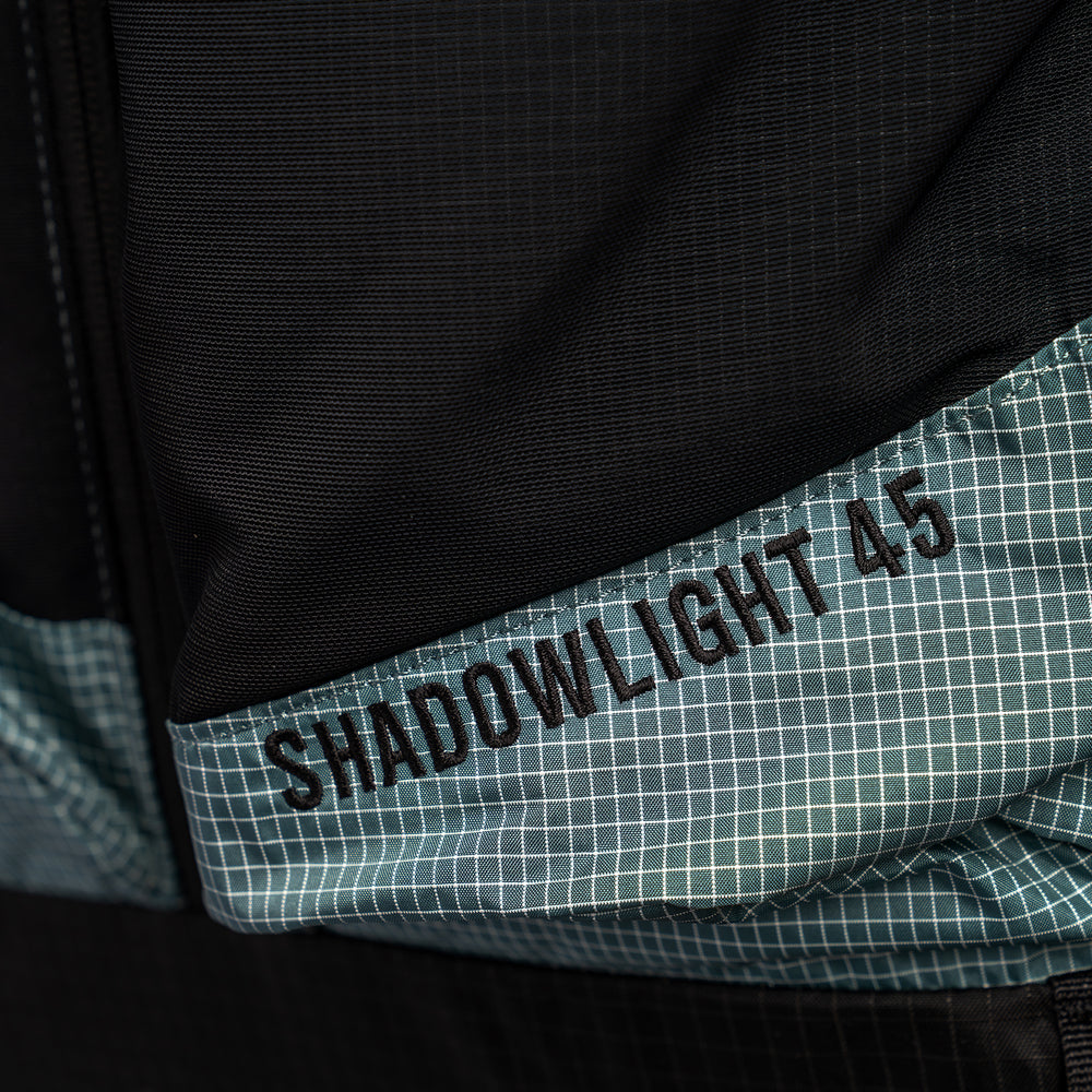 Detailed view of Shadowlight Ultralight Backpack capacity rating below mesh pockets