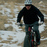 side view of mountain biker wearing men's technical hoodie
