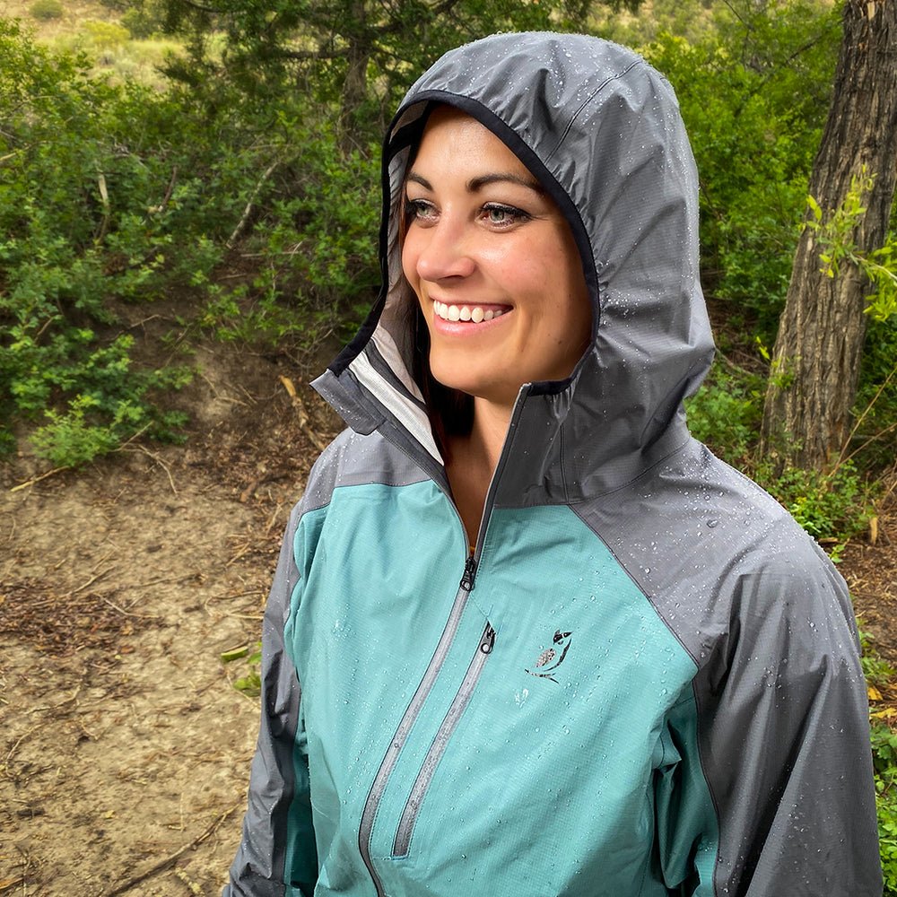 woman smiling while wearing ultralight rain jacket for backpacking