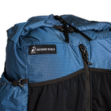 Close-up of the roll top & label on top of the Shadowlight Ultralight Backpack