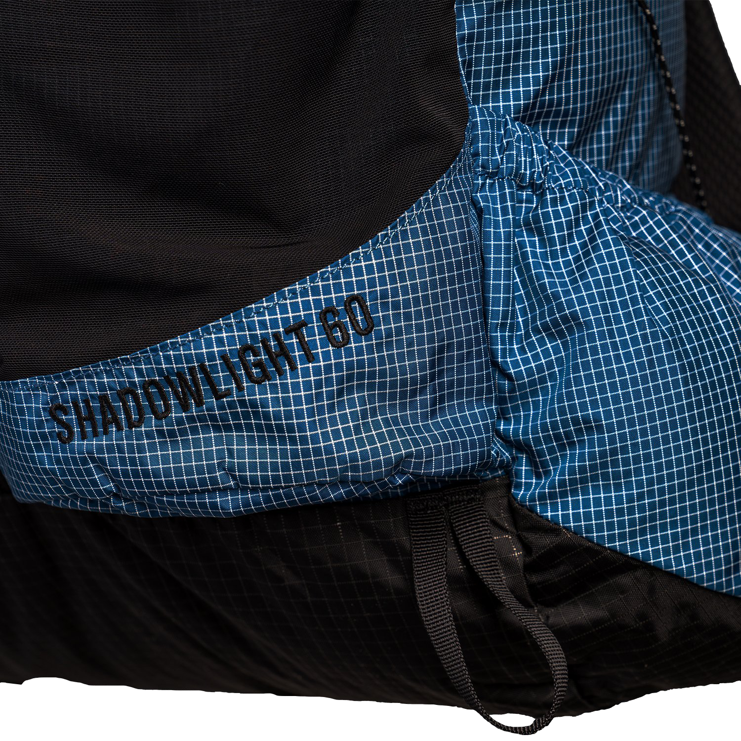 The Shadowlight Ultralight Backpack featuring a blue and black color scheme & 60L capacity