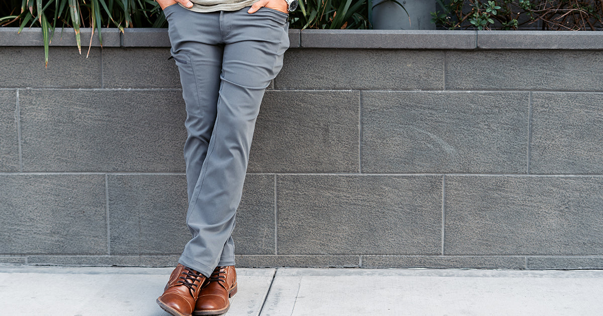 front view of man wearing charcoal trail pants in the city
